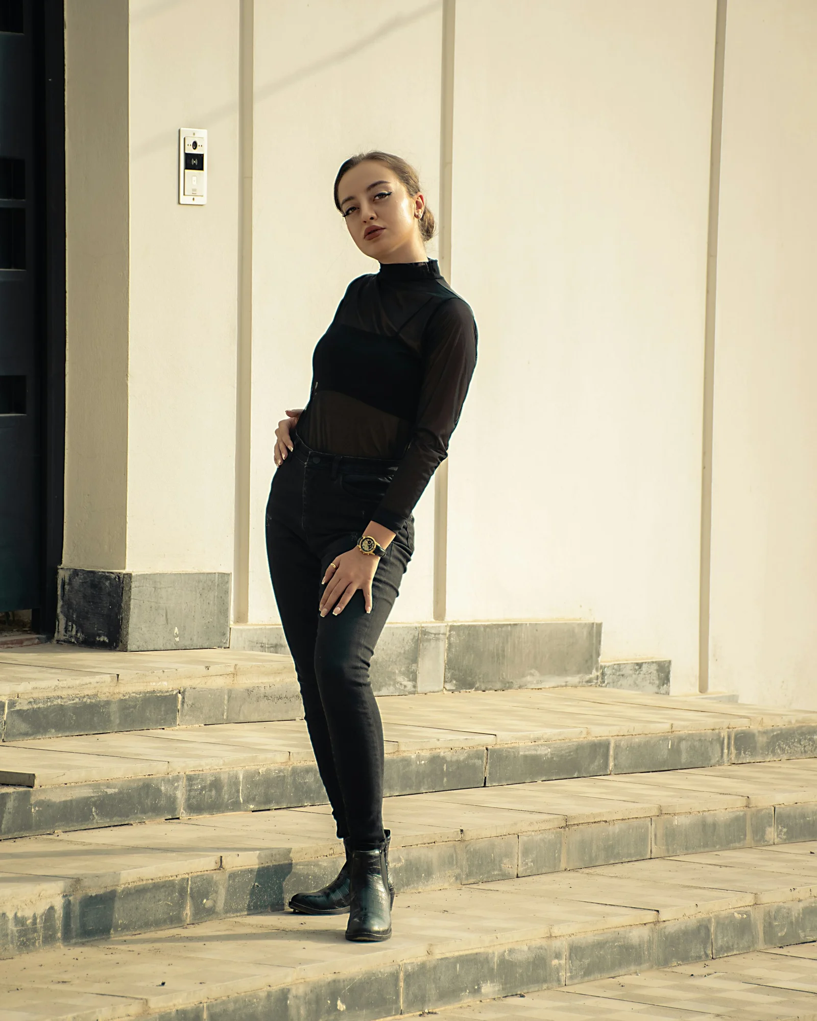 A woman standing on some steps in front of a building
