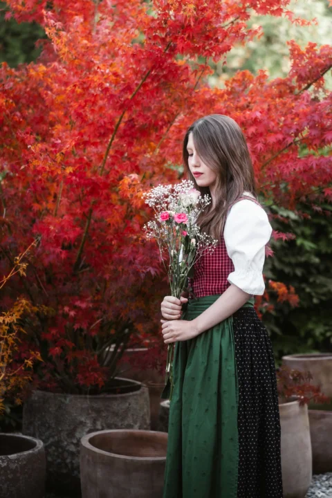 Young woman in traditional dress holding flowers