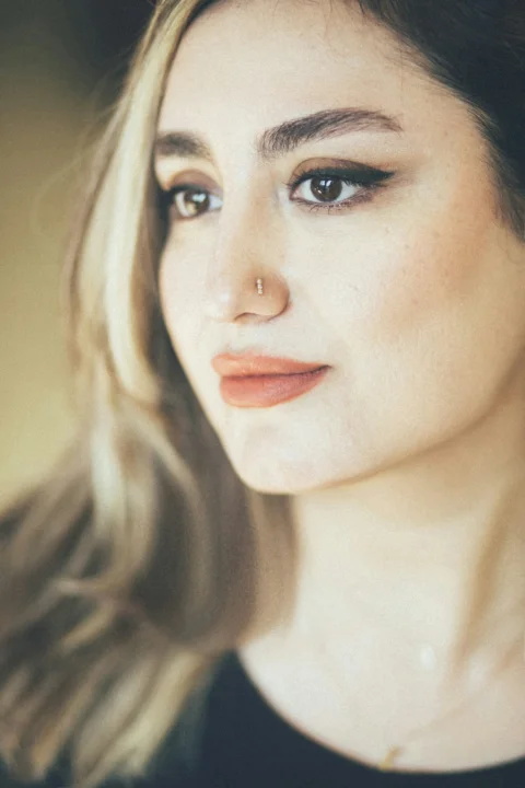 A close up of a person wearing a necklace
