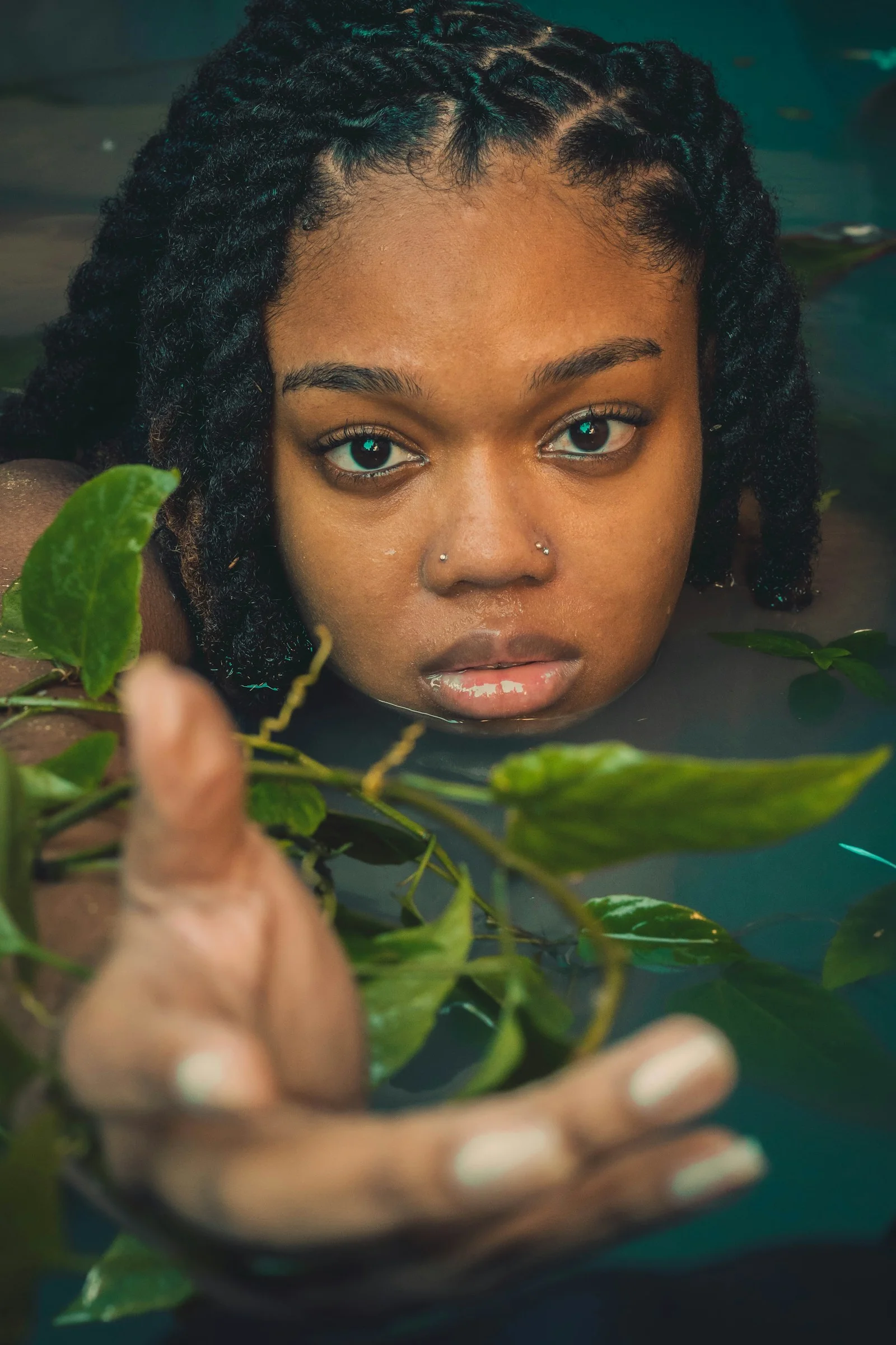 a woman holding a plant in her hands