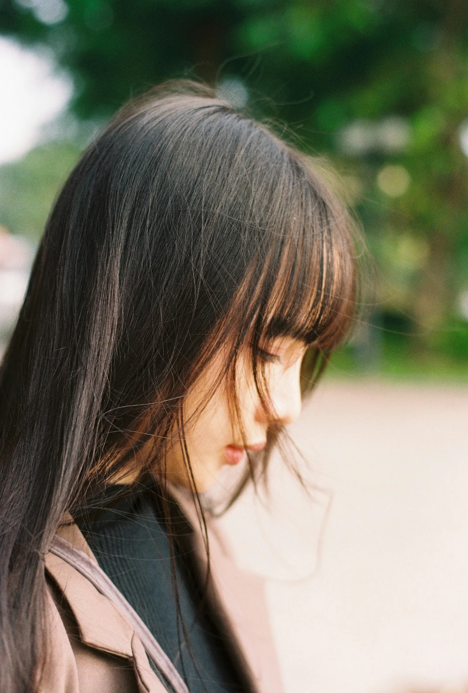 A young woman with long dark hair outdoors