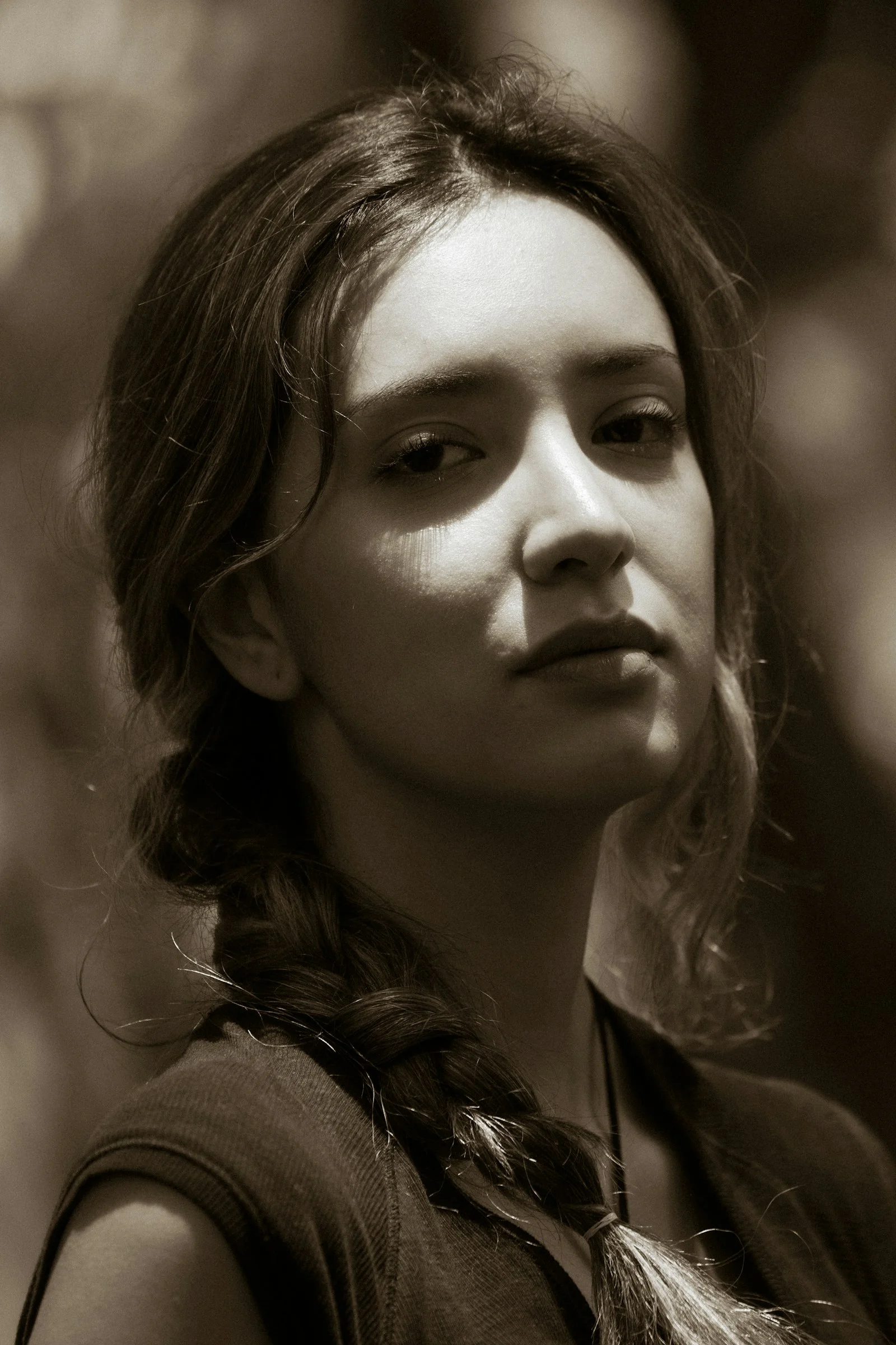 Sepia portrait of a young woman with braided hair