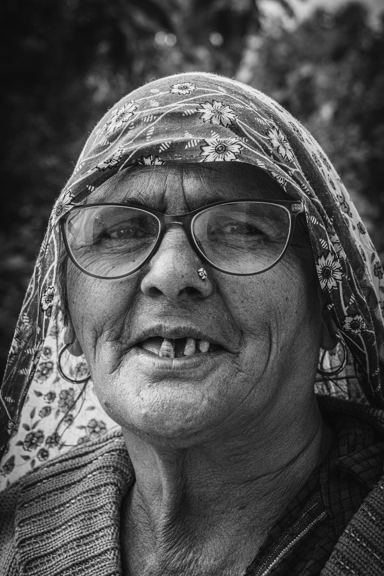 A black and white photo of a woman wearing glasses