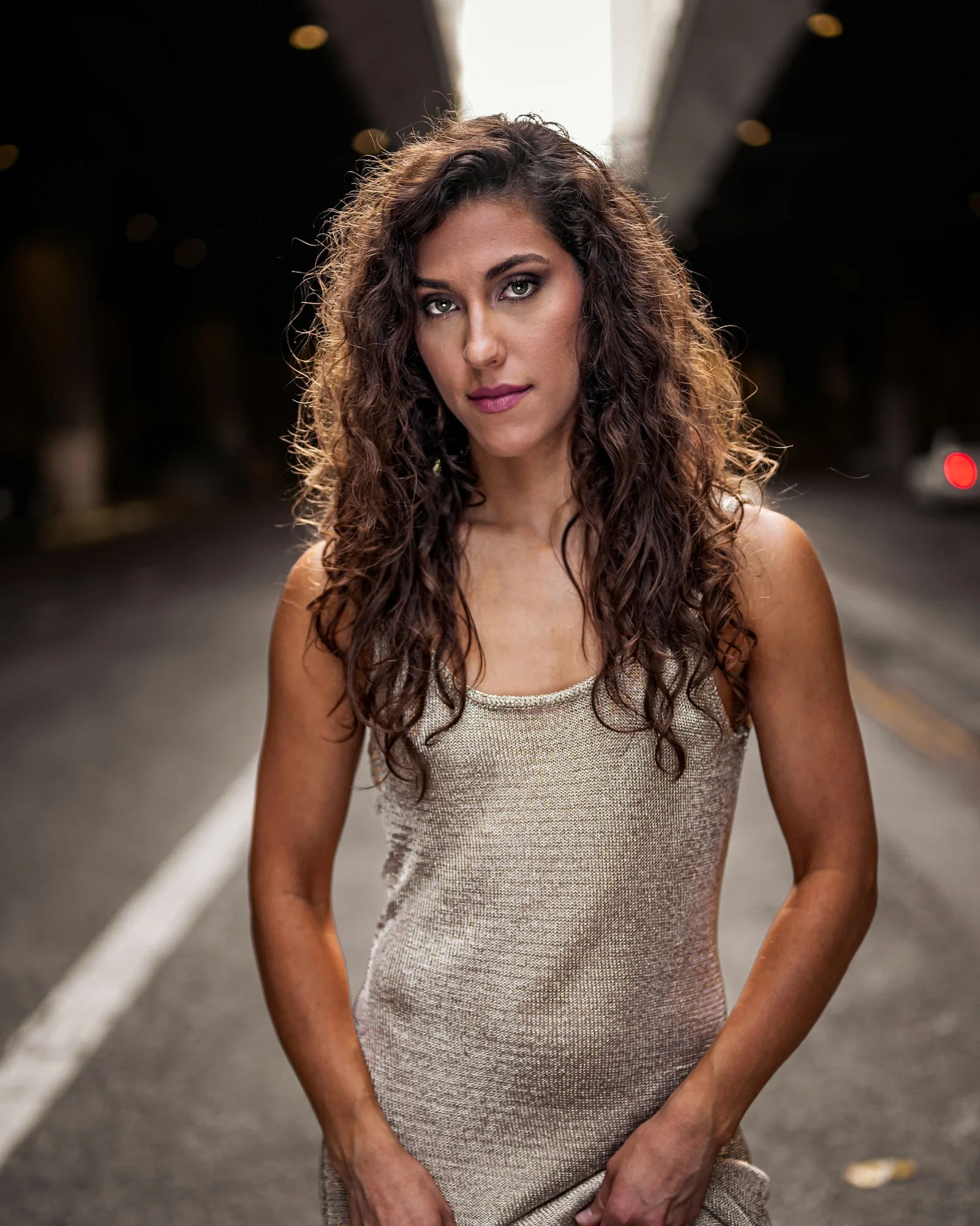 a woman standing in the middle of a street