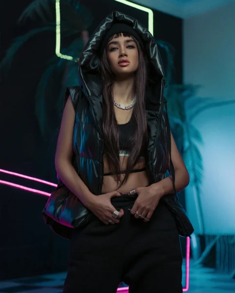 a woman wearing a black jacket and black pants