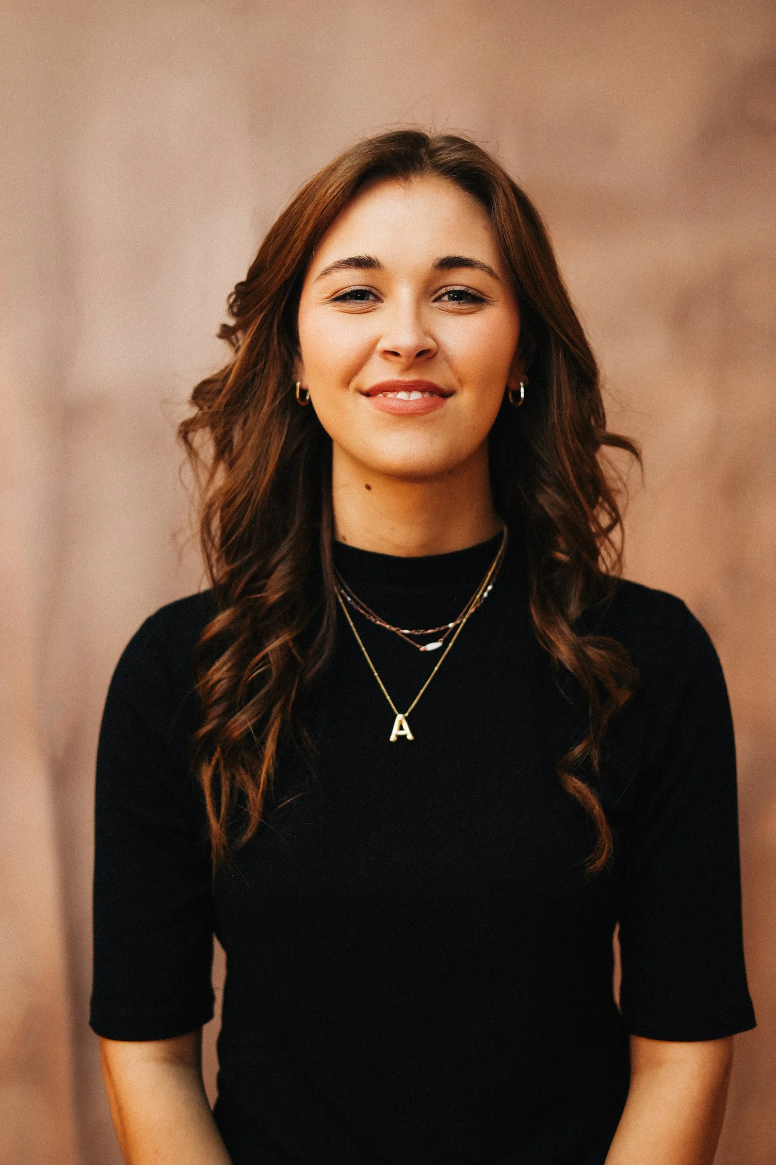 A smiling woman poses for a portrait