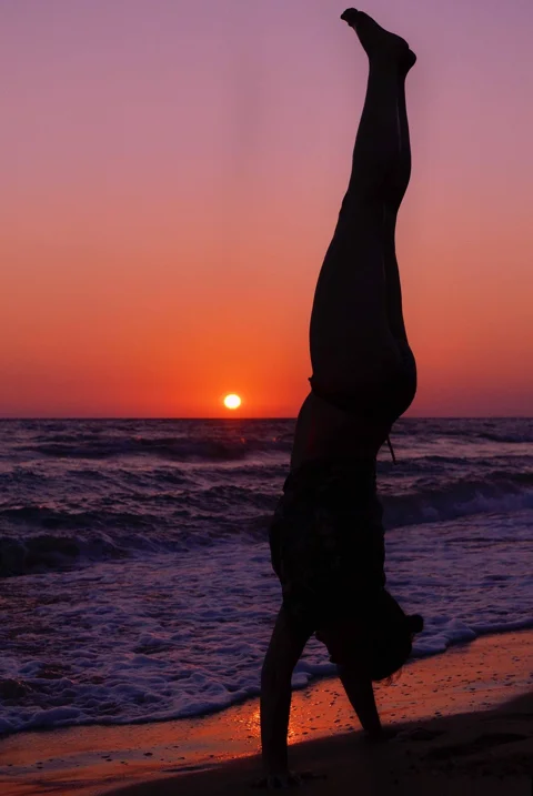 woman silhouette standing on hands, sunset beach seascape, landscape, sivota