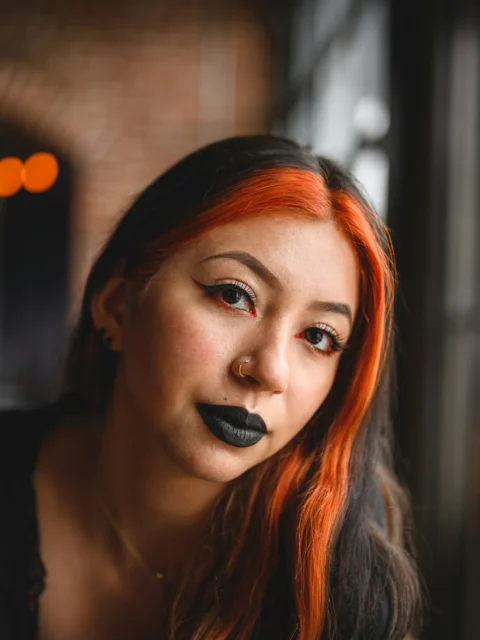 a woman with red hair and black lipstick