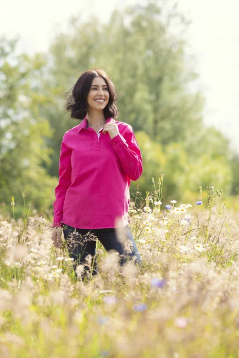A woman standing in a field of tall grass