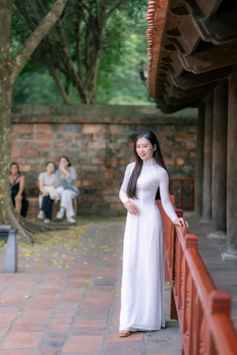 A woman poses in traditional vietnamese attire
