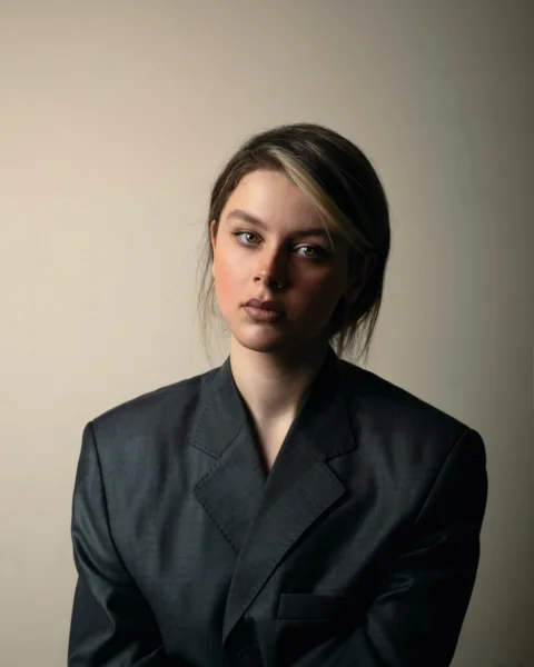 A woman in a black suit posing for a picture