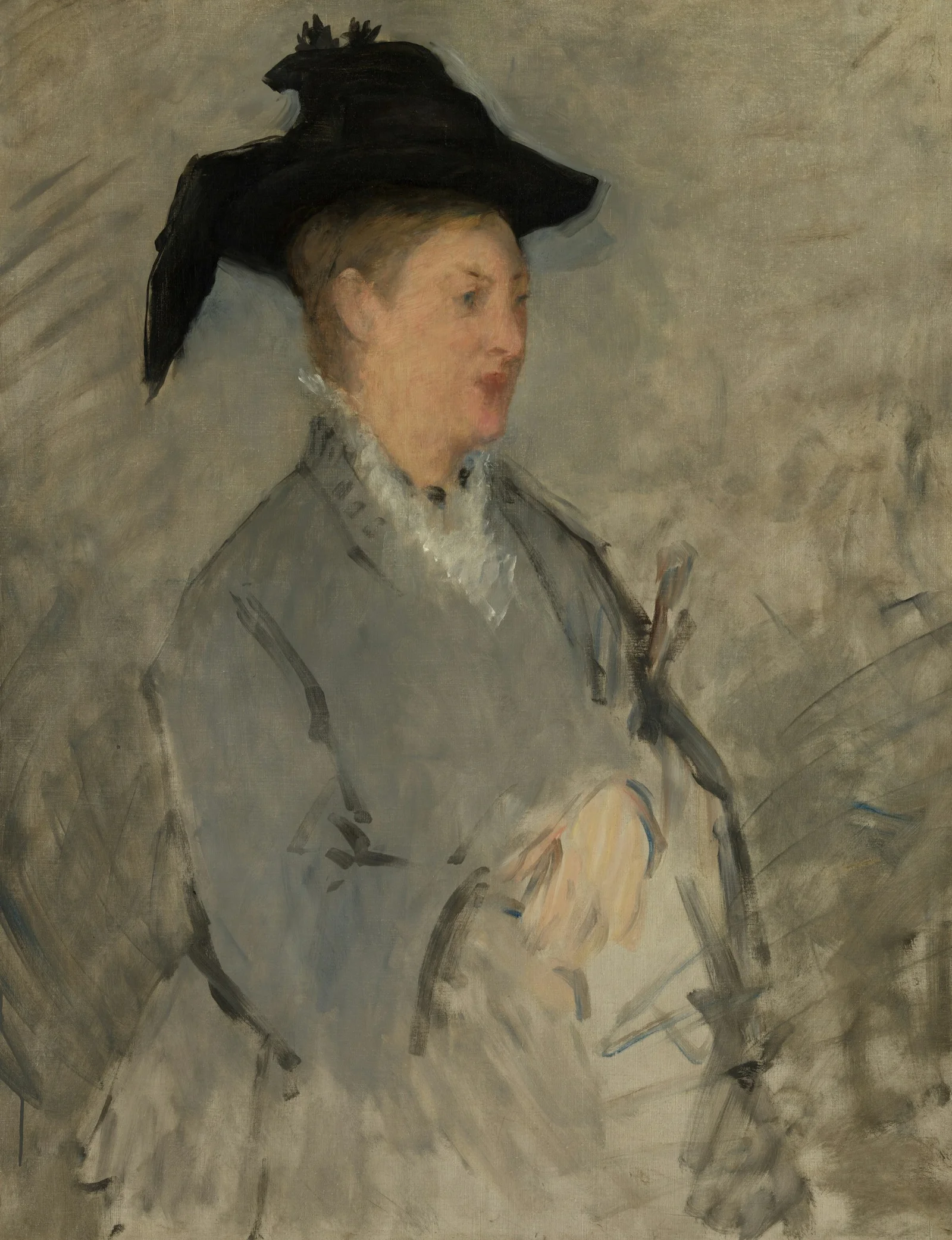 A woman in a black hat and grey coat