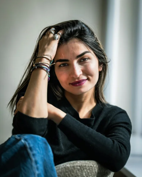 Woman looks at the camera with a slight smile