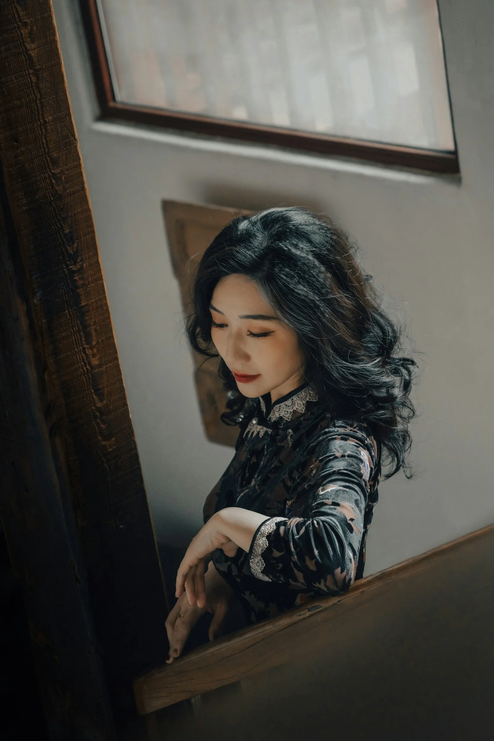A woman in traditional attire poses indoors