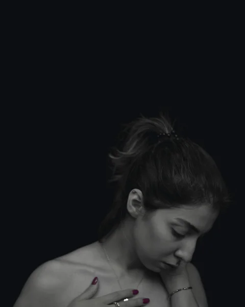 a woman in a black and white photo holding a cell phone