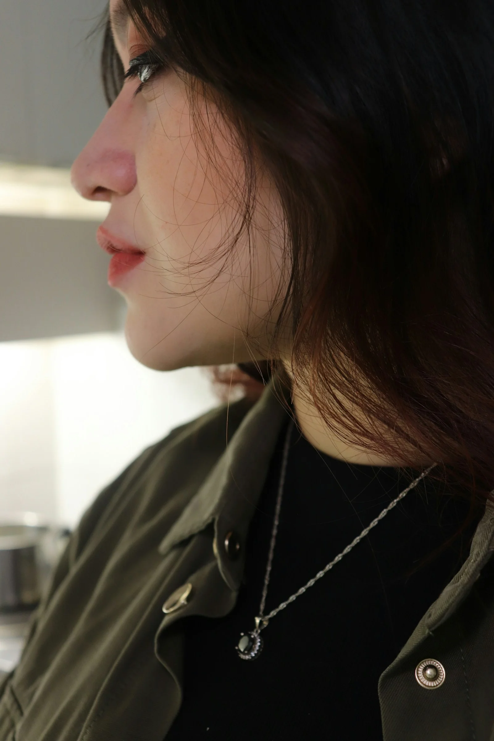 a close up of a person wearing a necklace