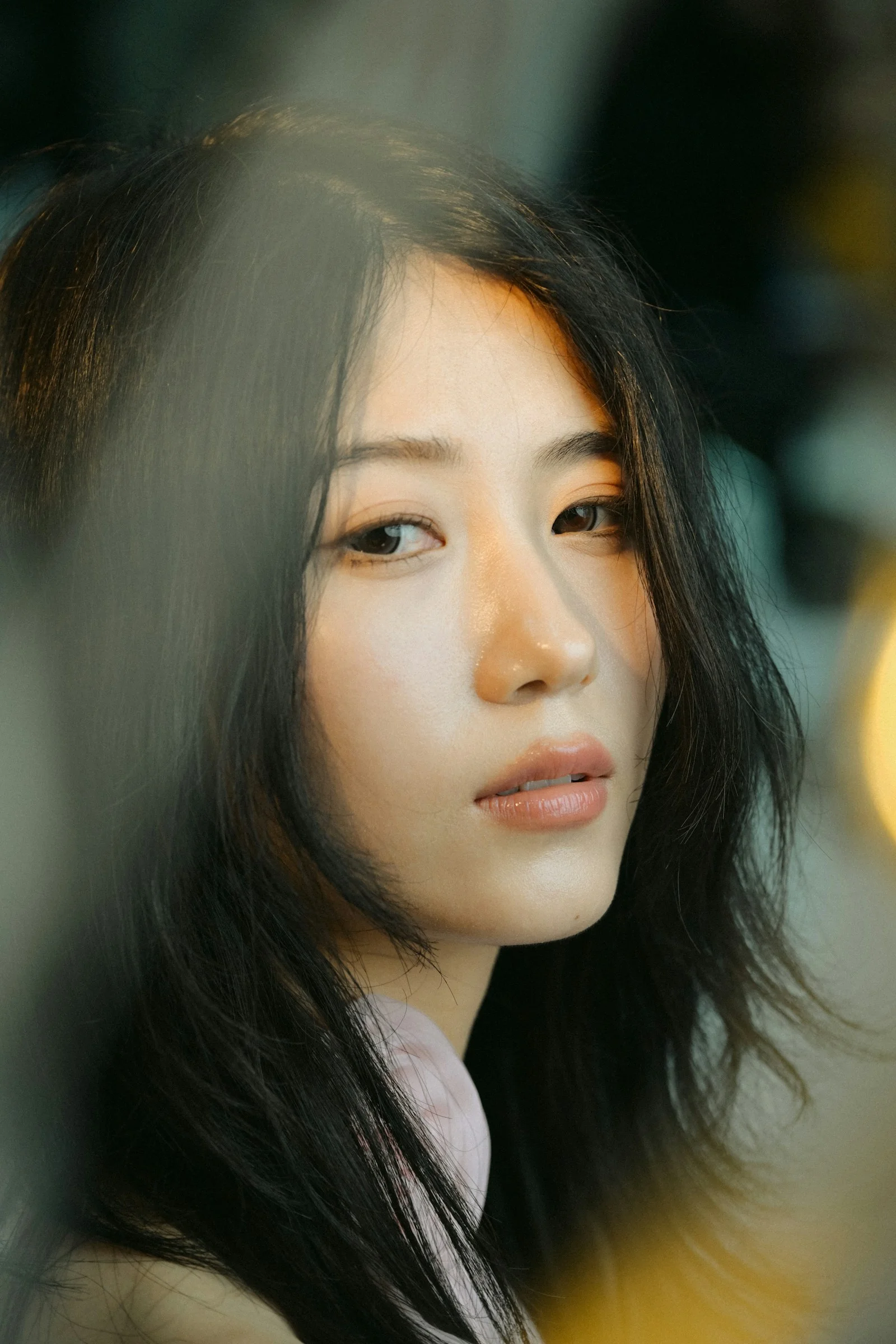 A young woman with dark hair looking forward