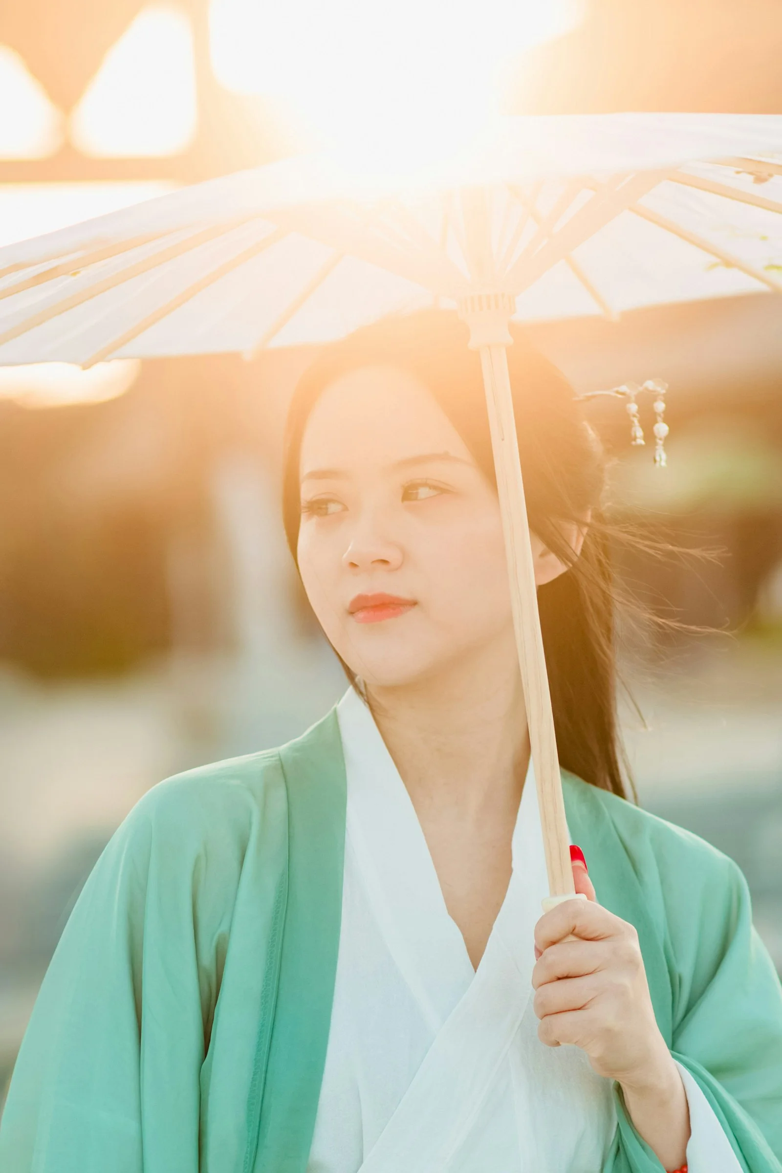 a woman in a kimono holding an umbrella