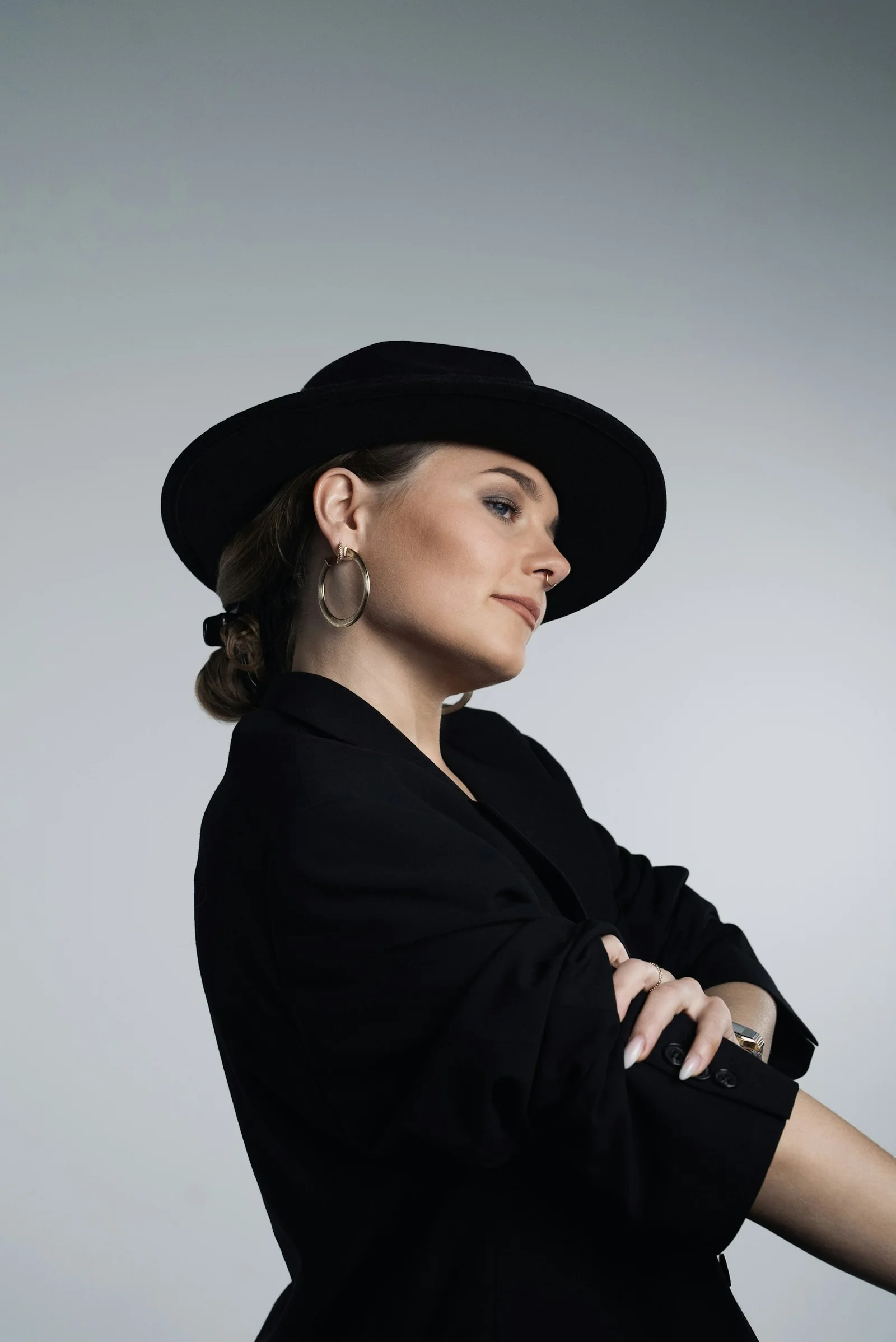 a woman wearing a black hat and a black jacket
