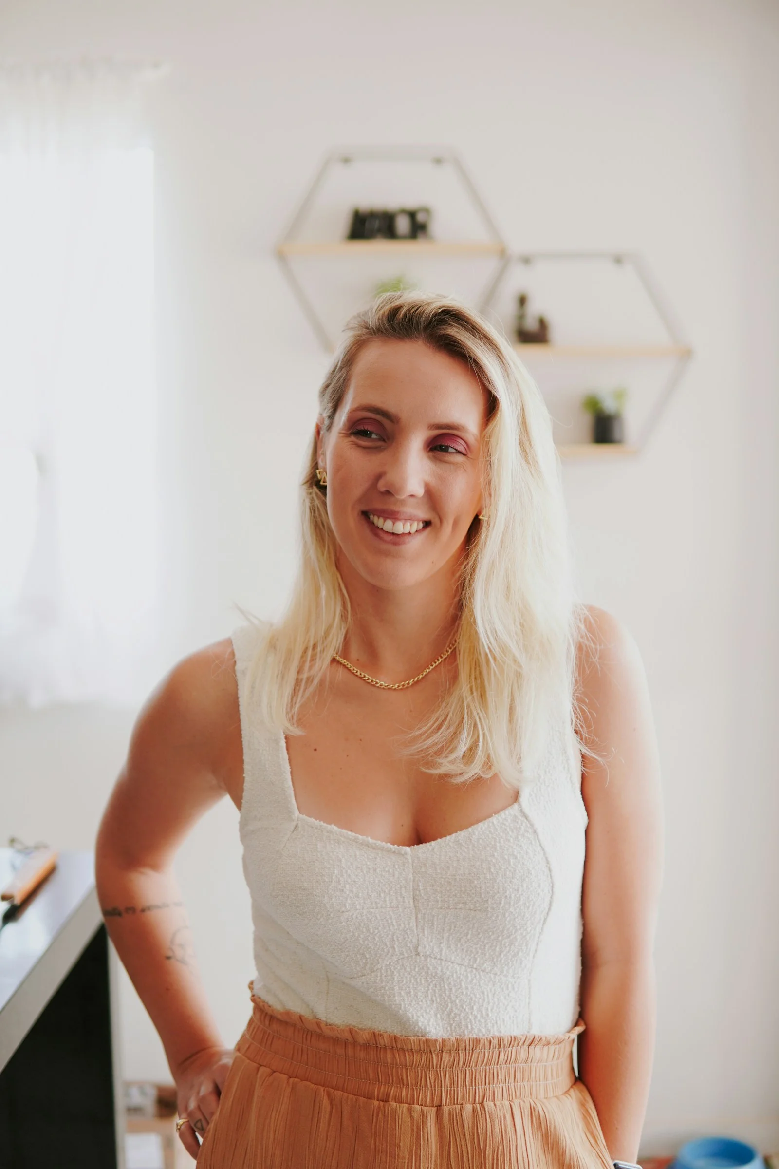 a woman standing in a kitchen with her hands on her hips