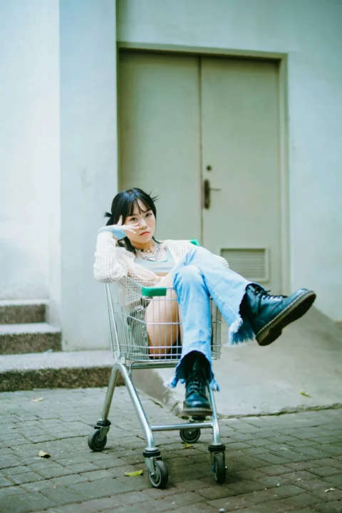 一名坐在购物车顶上的女子