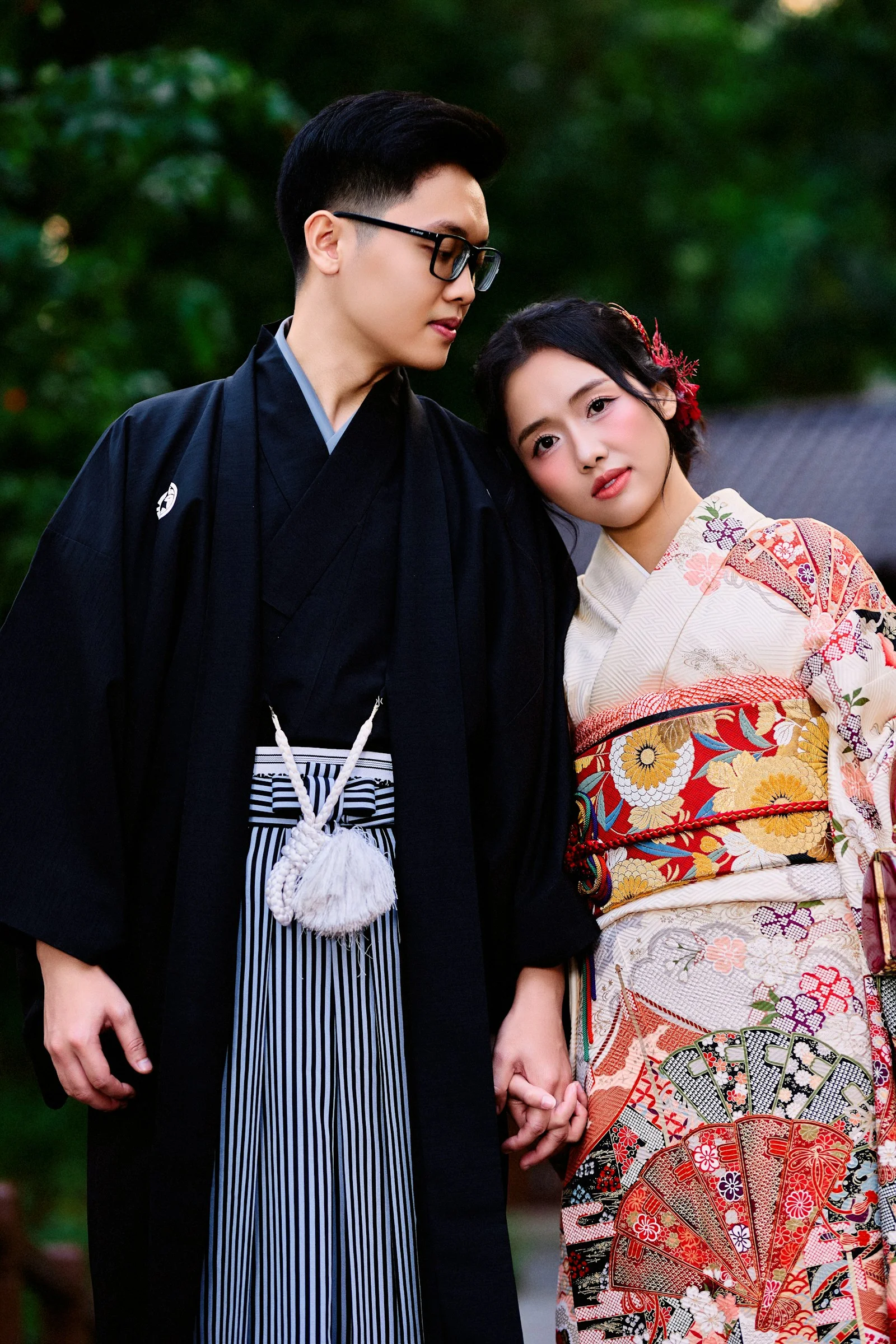 A couple in traditional japanese kimonos holding hands