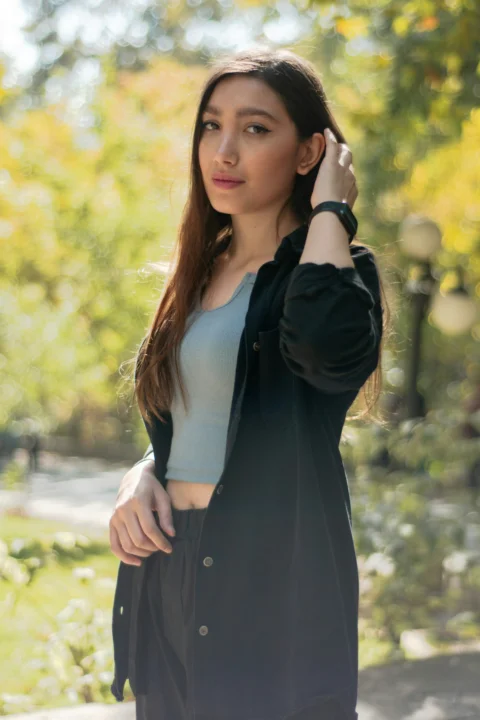 Young woman with long brown hair in park