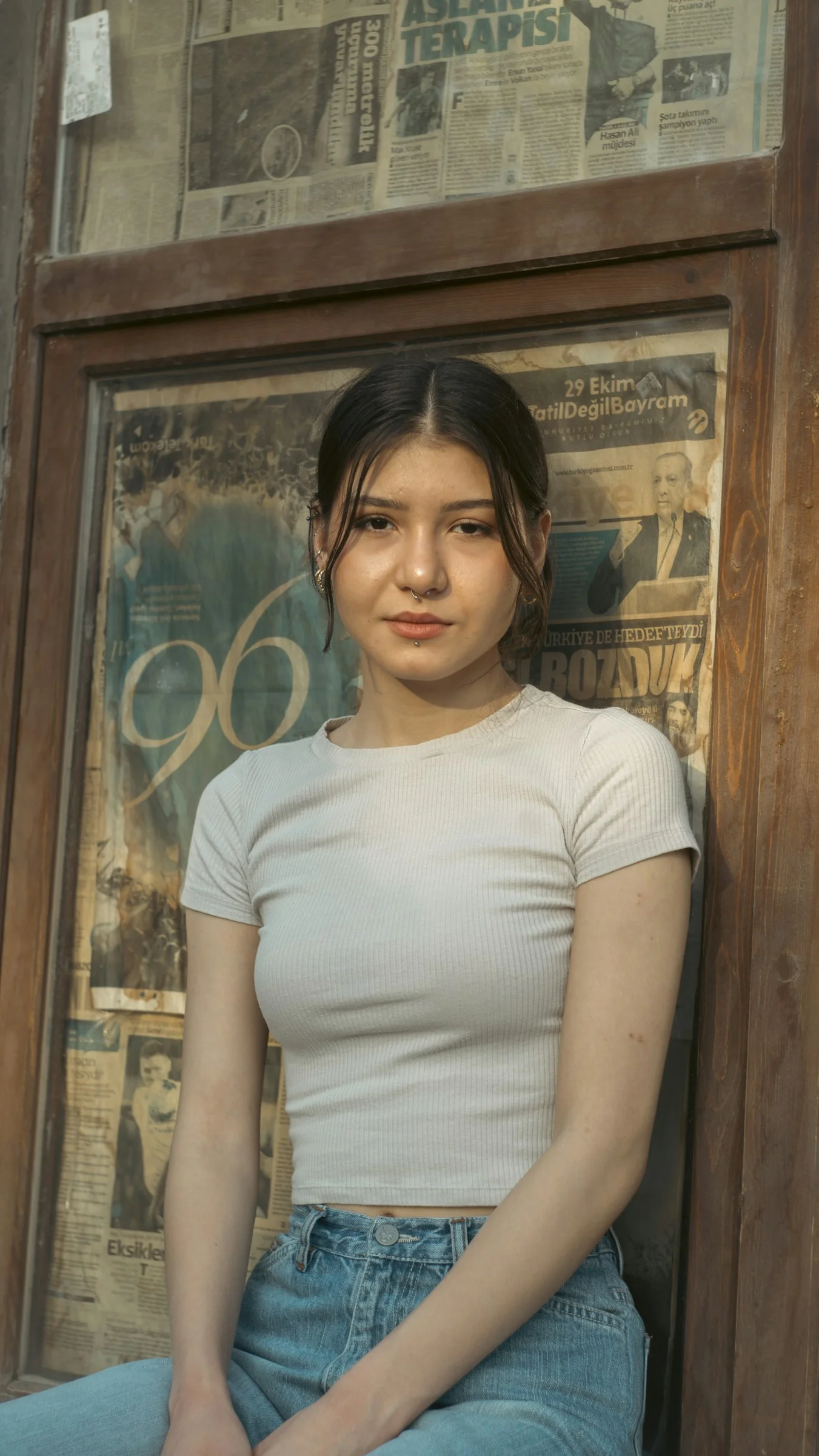 a woman sitting on the ground in front of a window
