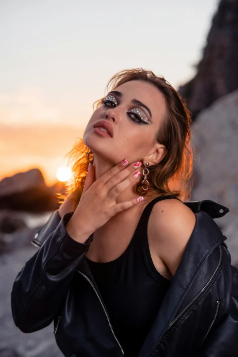 Woman with dramatic makeup at sunset