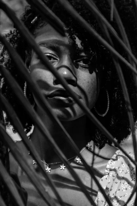 a black and white photo of a woman with large hoop earrings