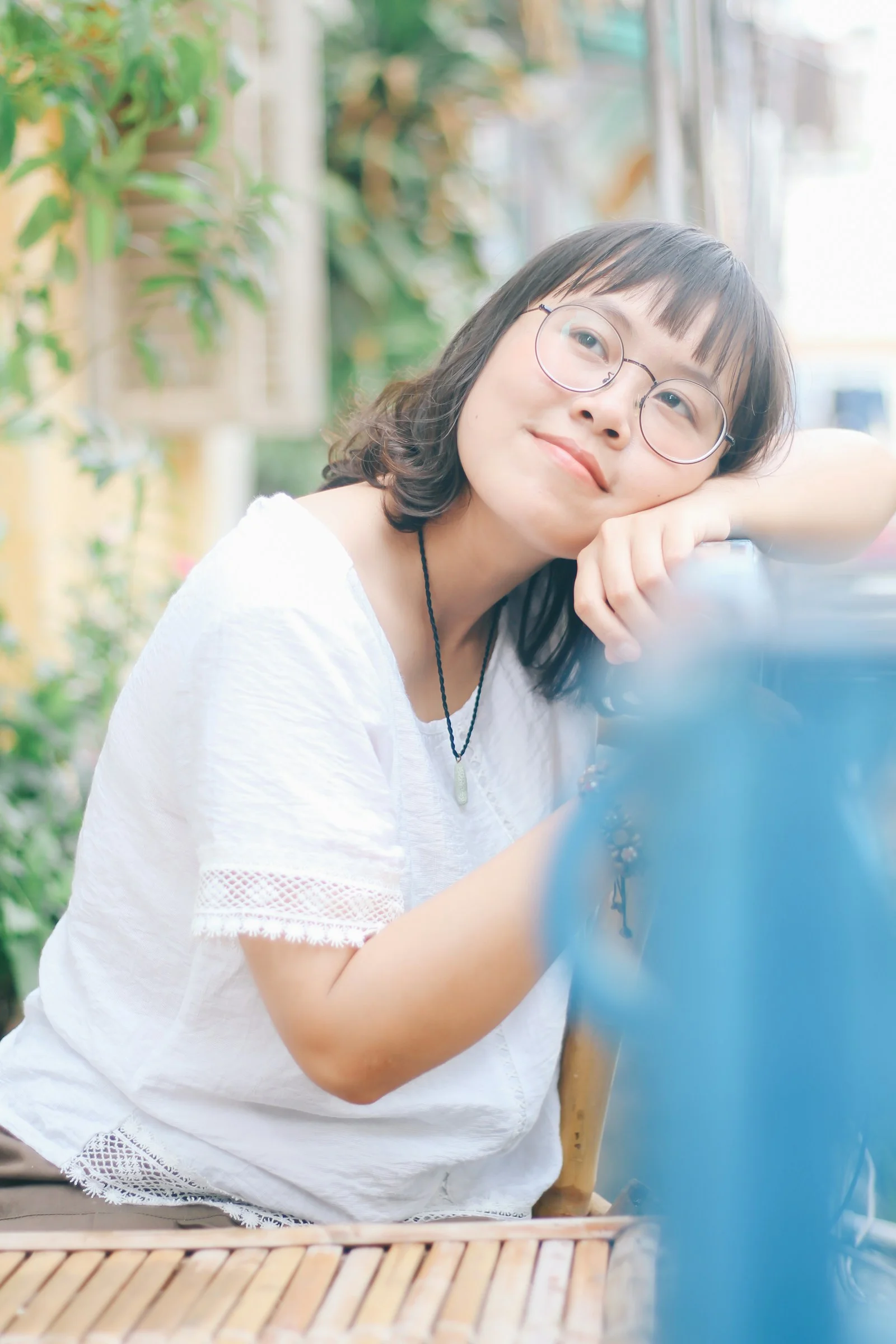 girl wearing eyeglasses sitting on chair during daytime