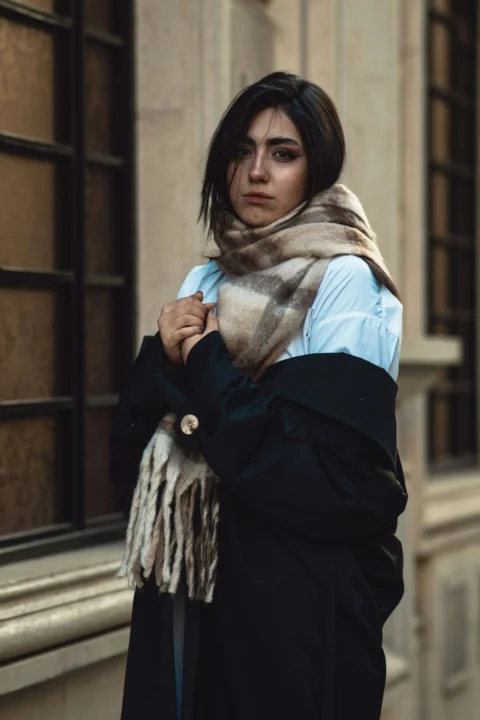 Young woman wearing a scarf and coat outside