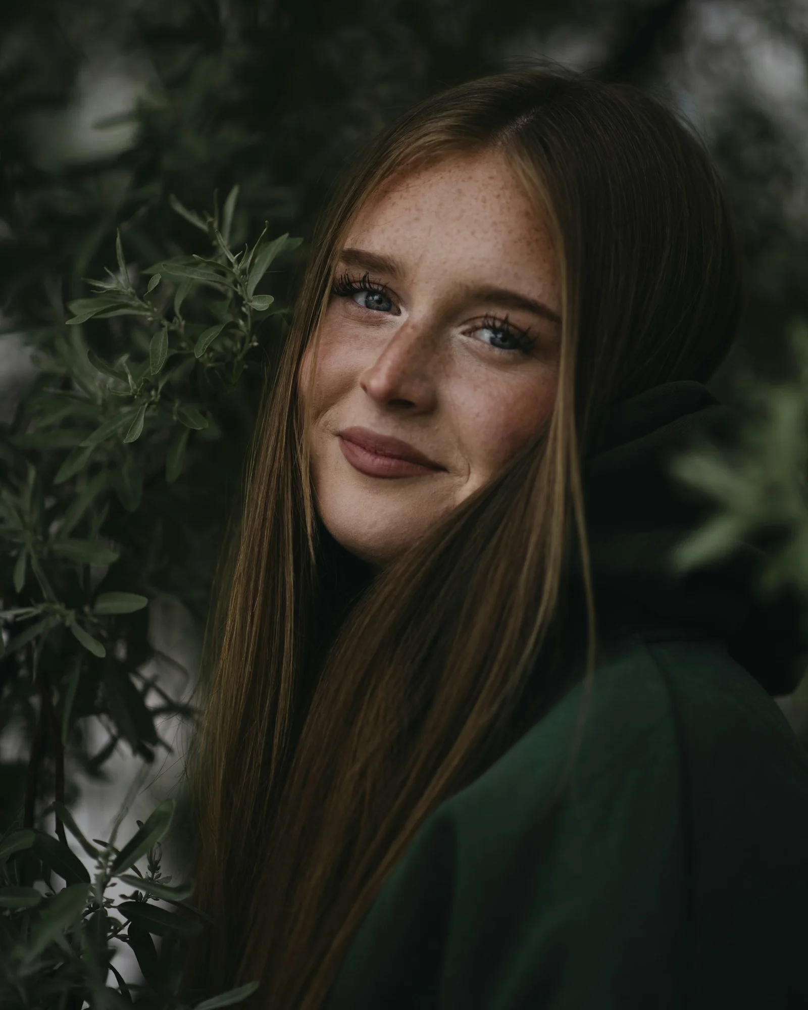 Beautiful woman smiles with green leaves