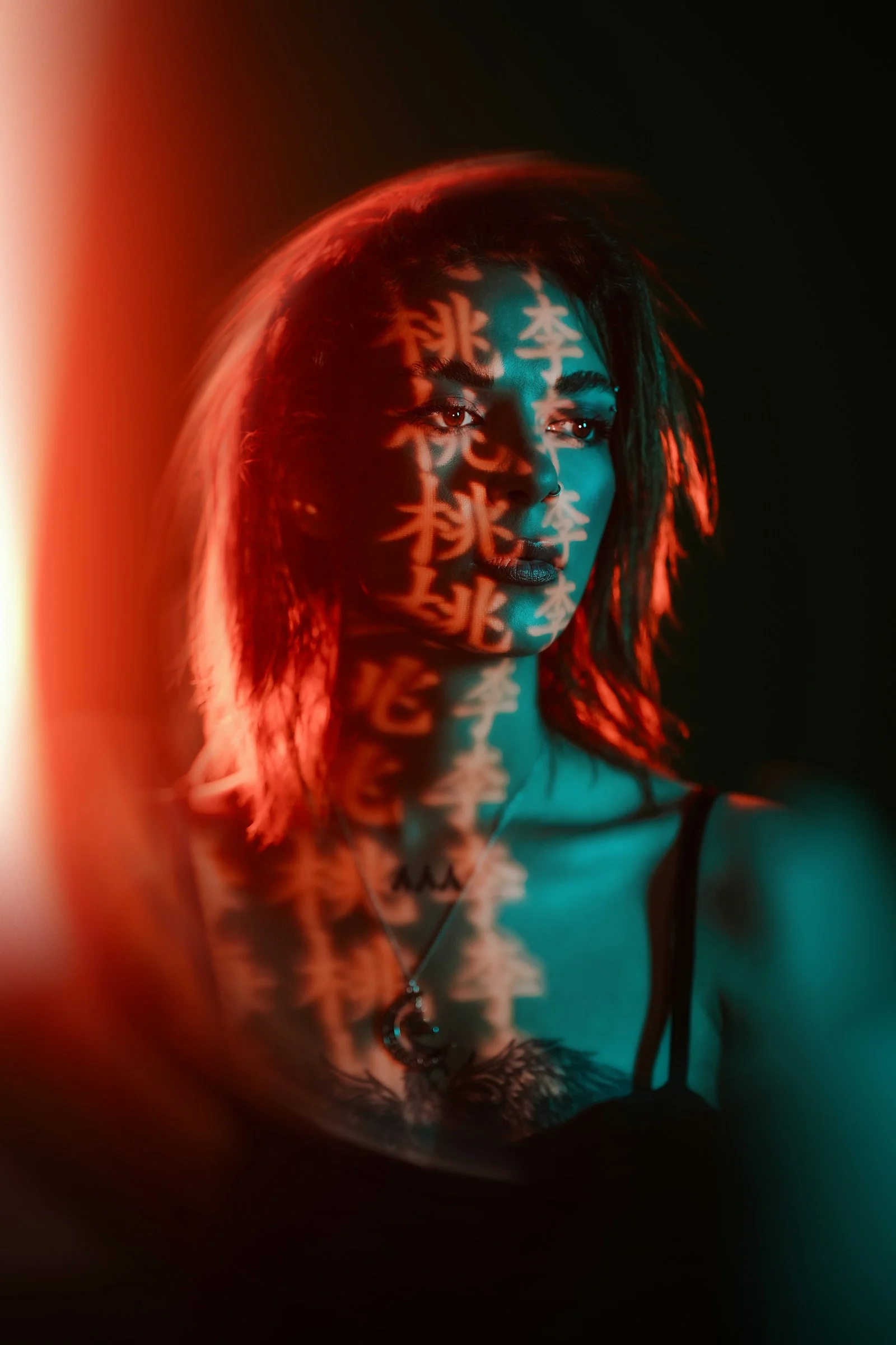 Woman with chinese characters projected onto her face