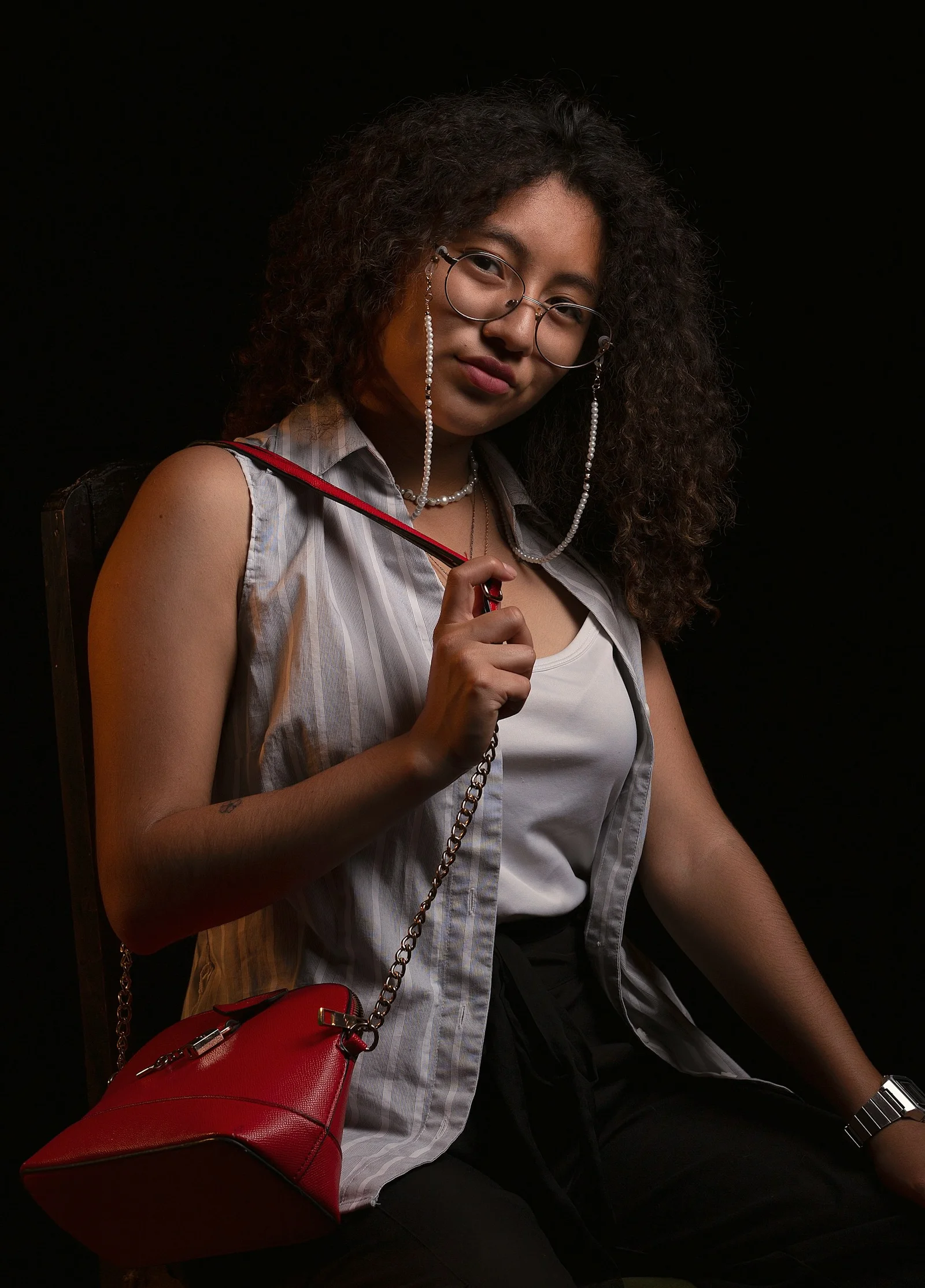 woman in white sleeveless shirt holding red and white electric guitar