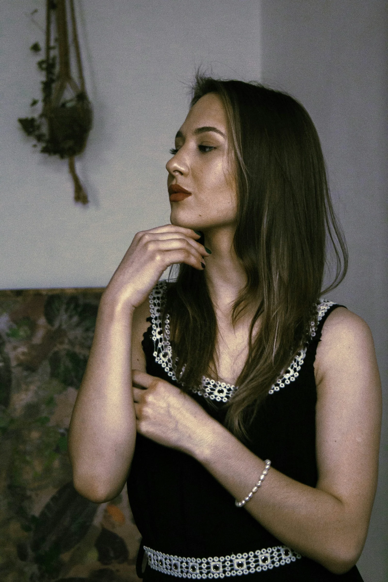 a woman in a black dress standing in a room