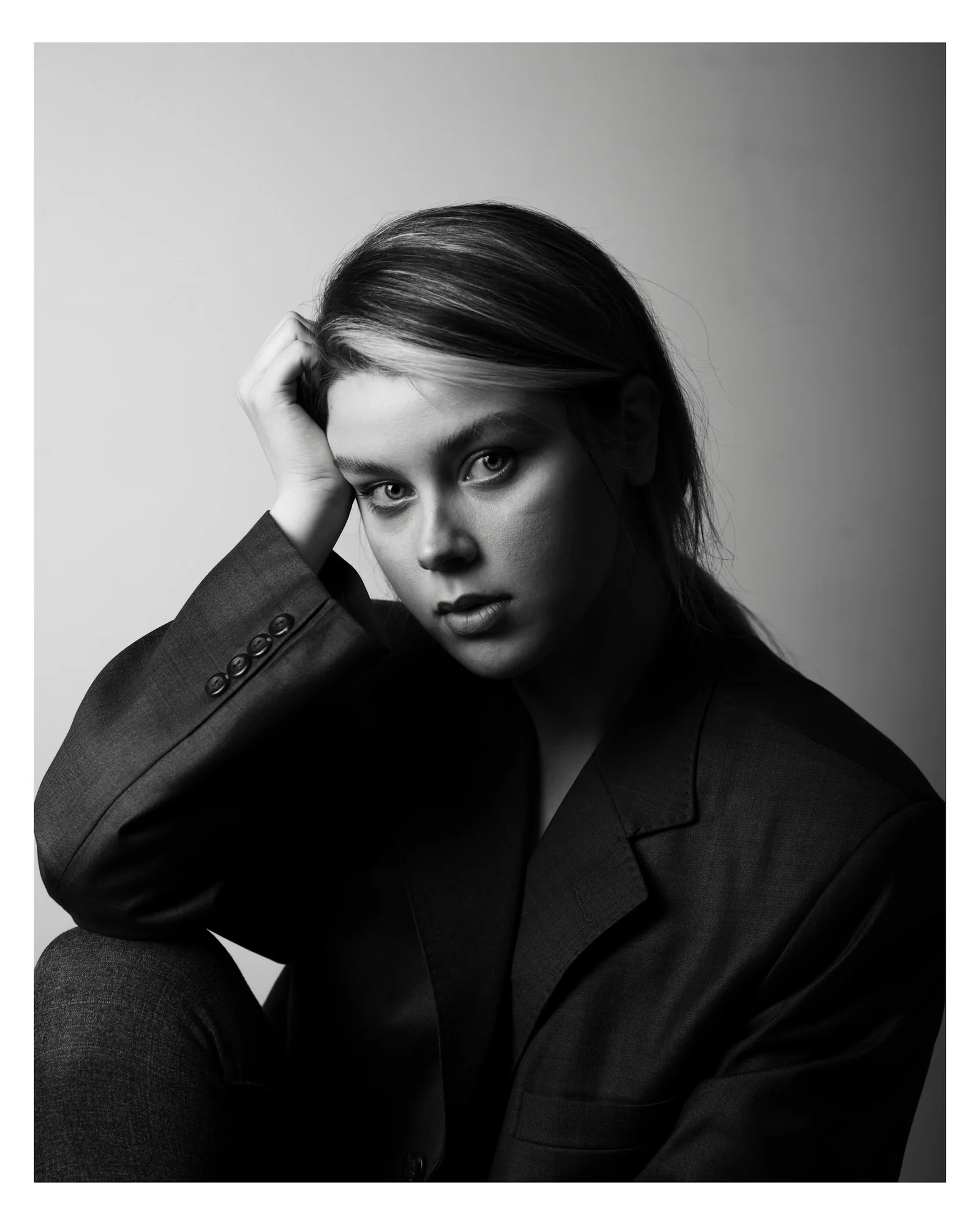 A black and white photo of a woman in a suit