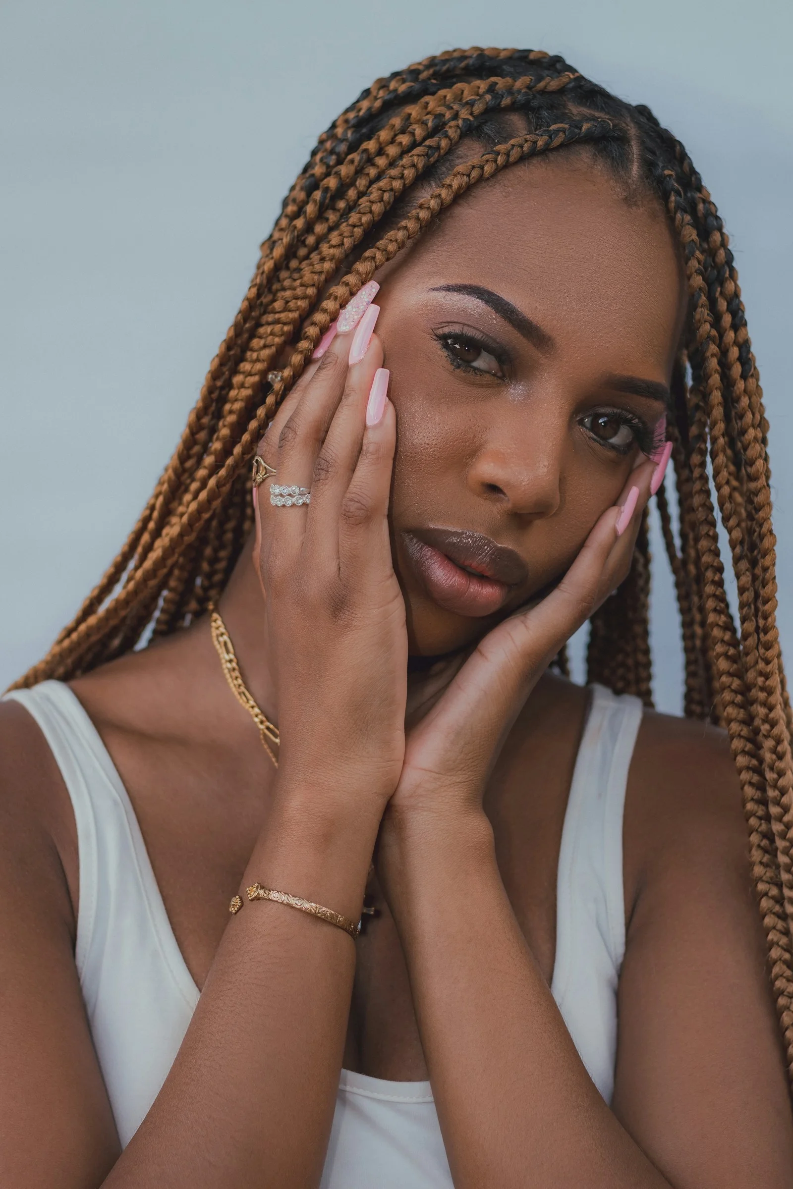 a woman with her hand on her face