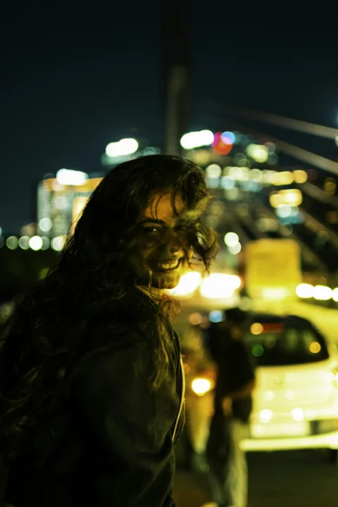 Woman smiles brightly in the night city