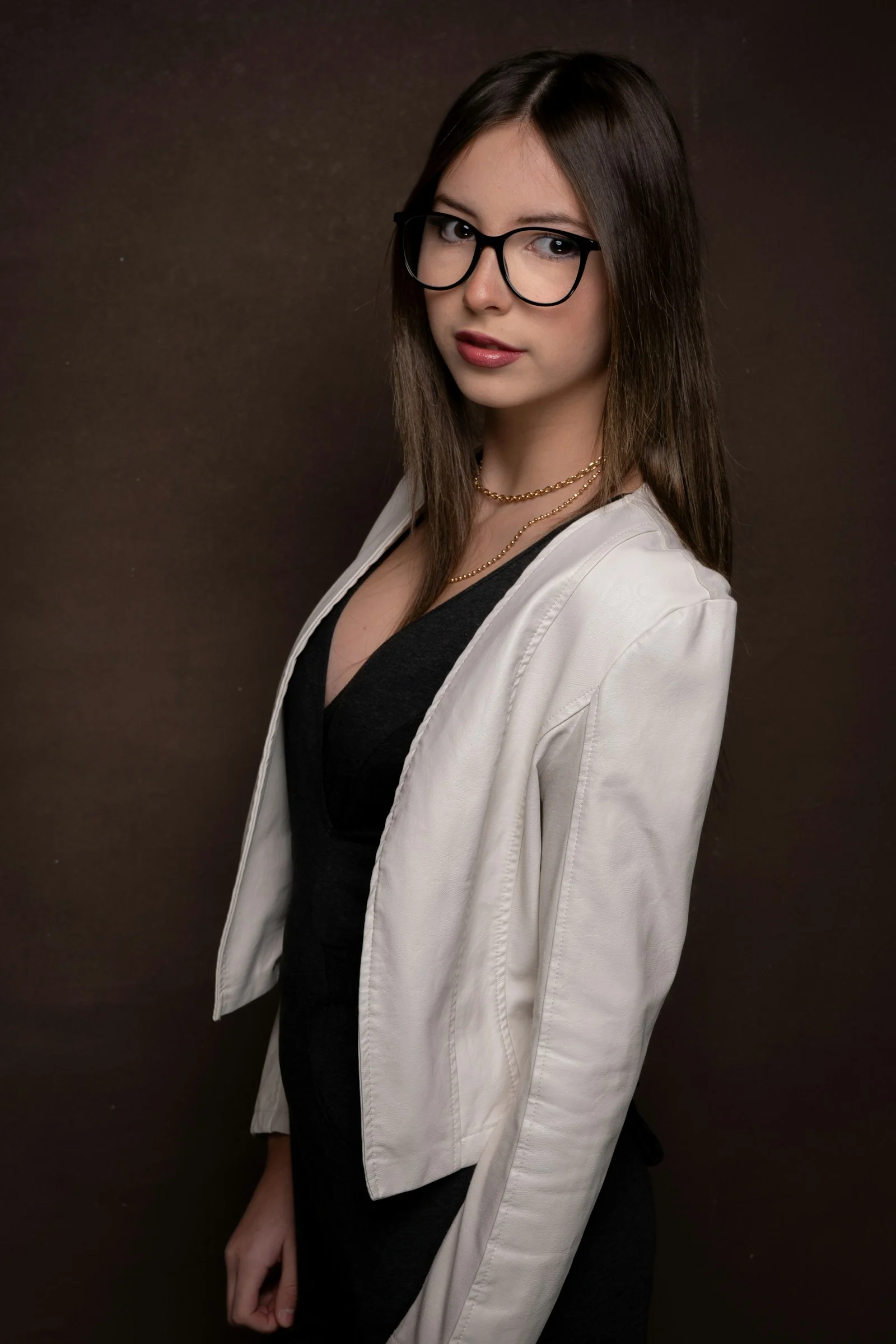 Young woman wearing glasses and a white jacket