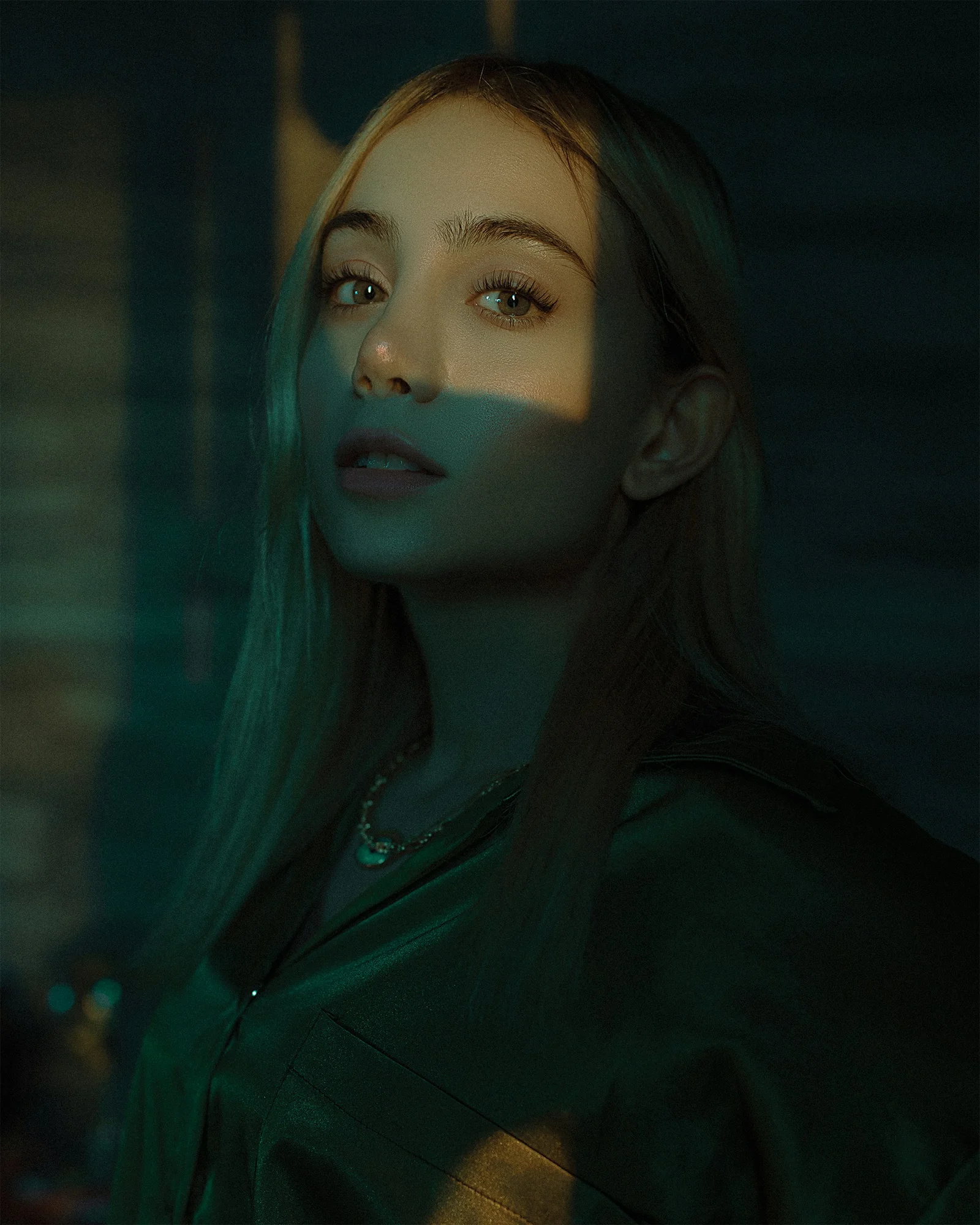 a woman with long hair standing in a dark room