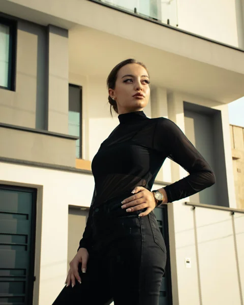 A woman standing in front of a building