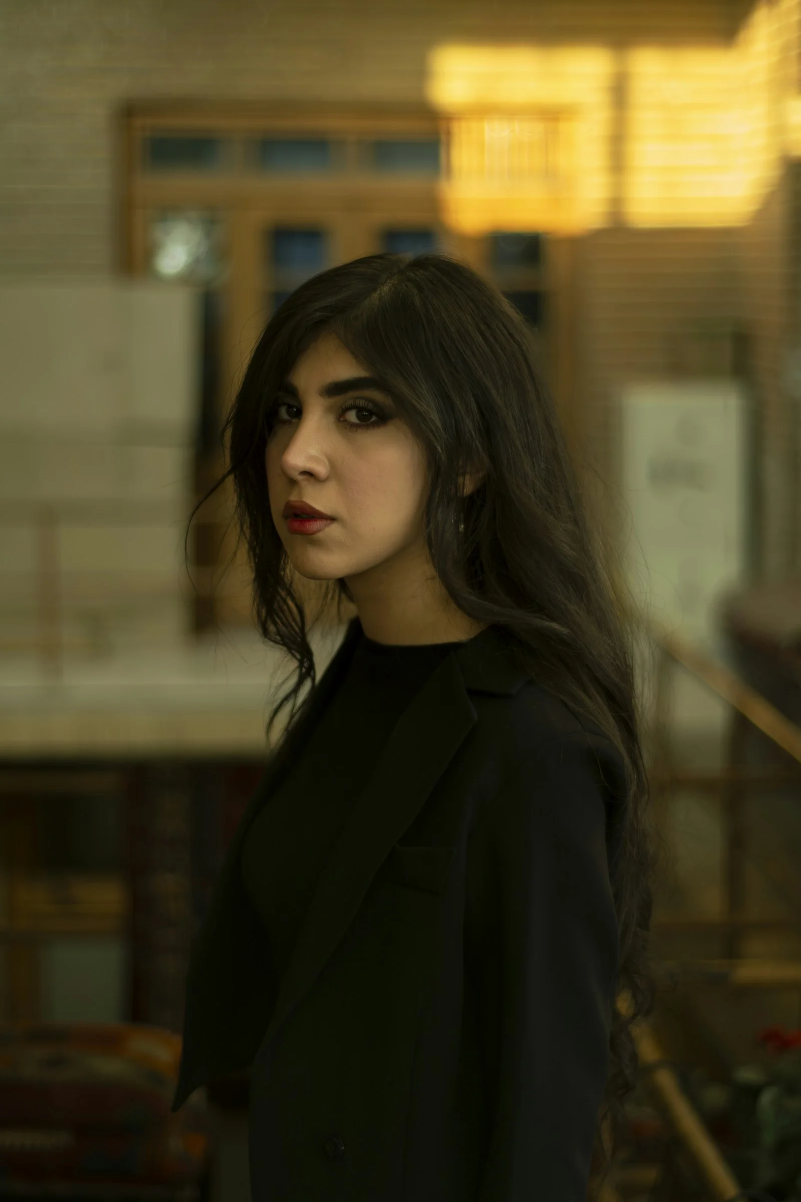 A woman with long hair standing in a room