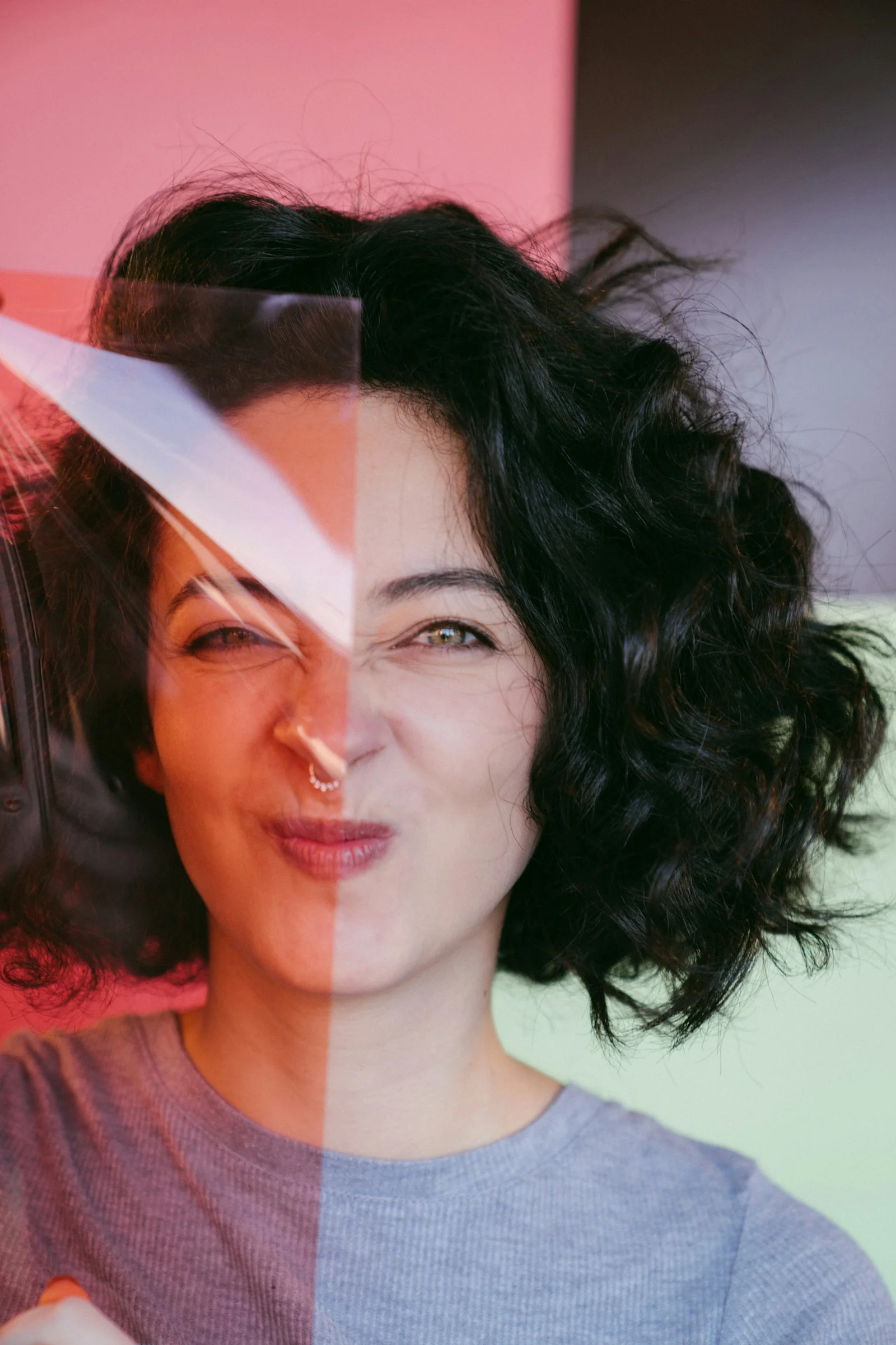 a woman holding a pair of scissors in front of her face