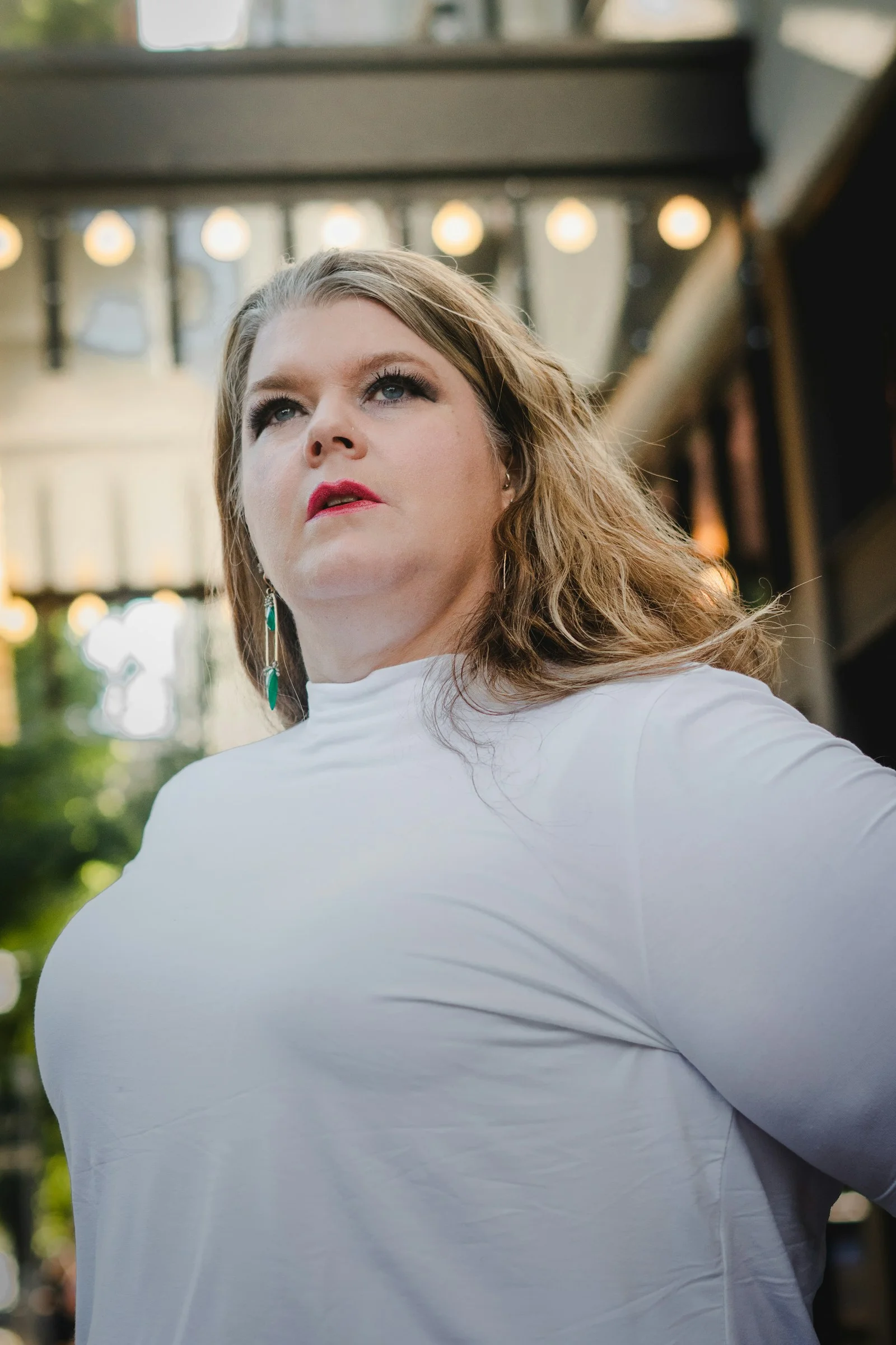 a woman standing in front of a building with her hands on her hips