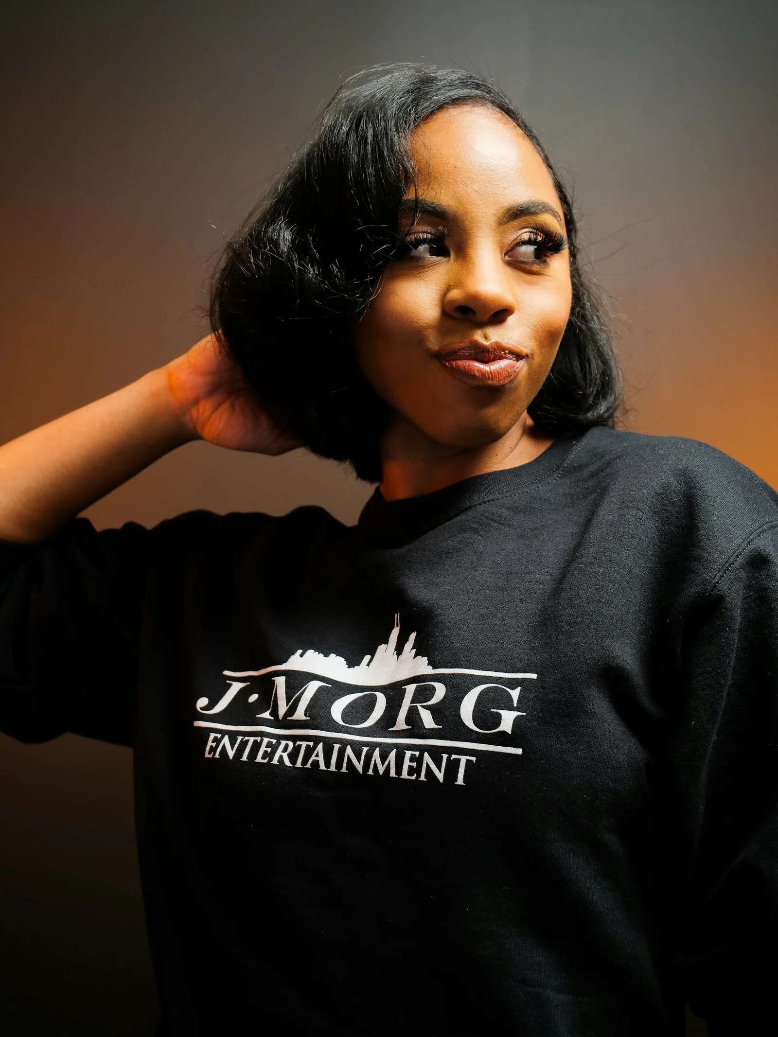 Young woman with short black hair wearing a black sweatshirt
