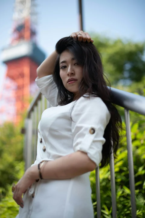 a woman in a white dress is posing for a picture