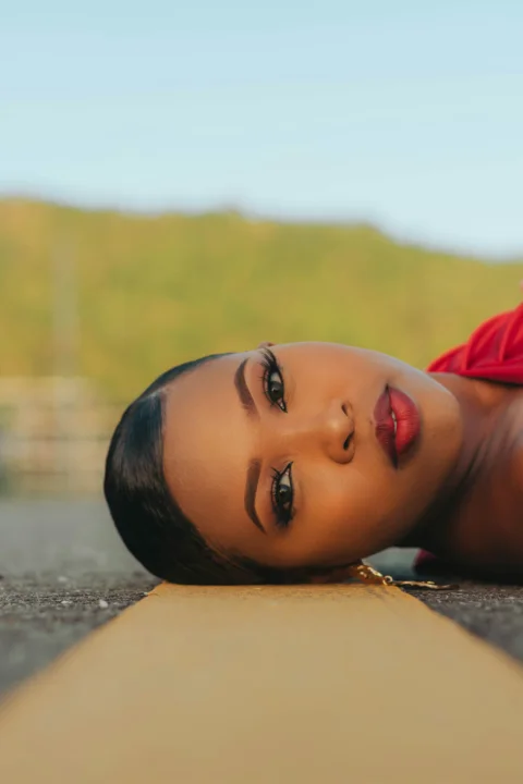 a woman laying on the ground with her eyes closed
