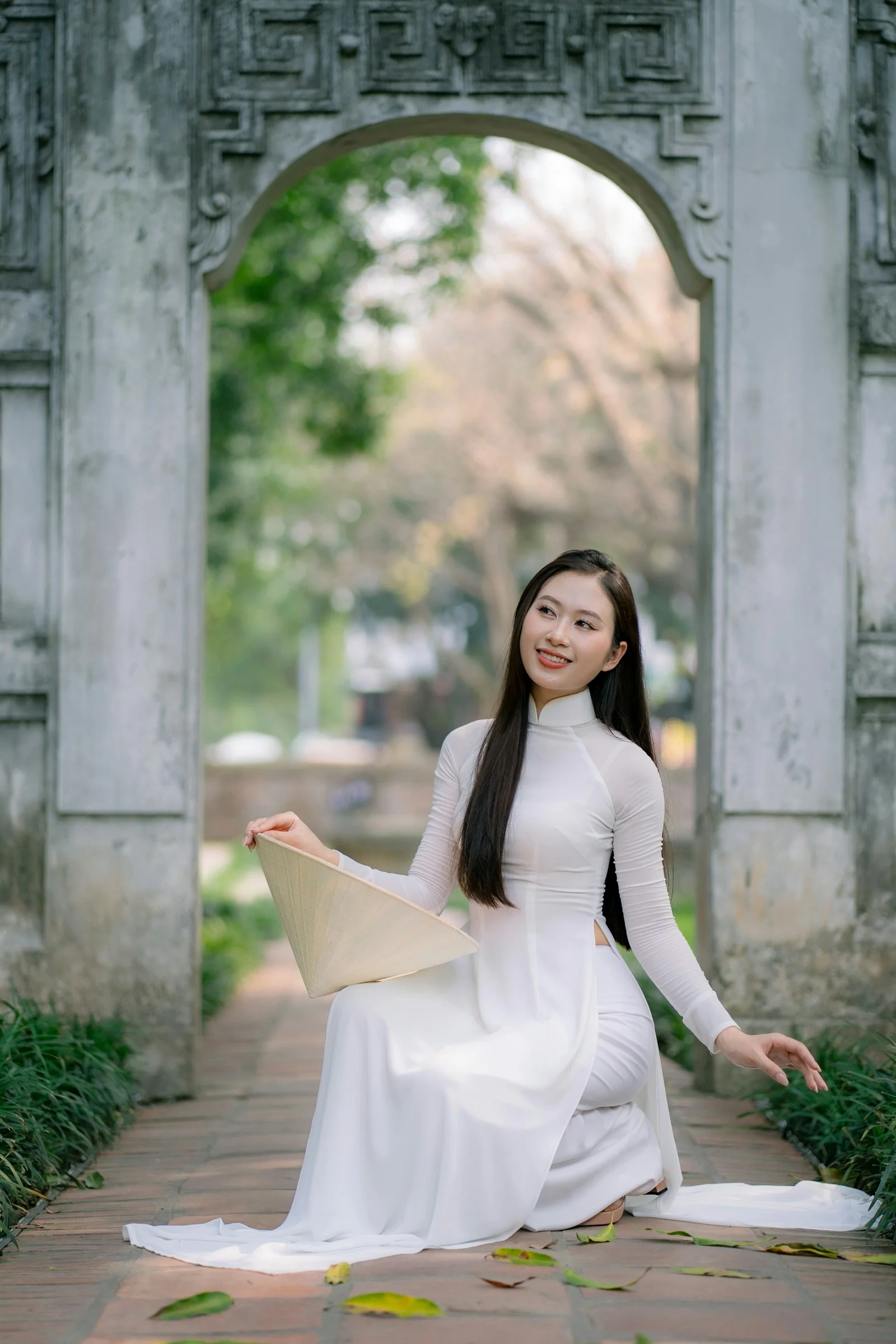 A woman poses in traditional vietnamese attire