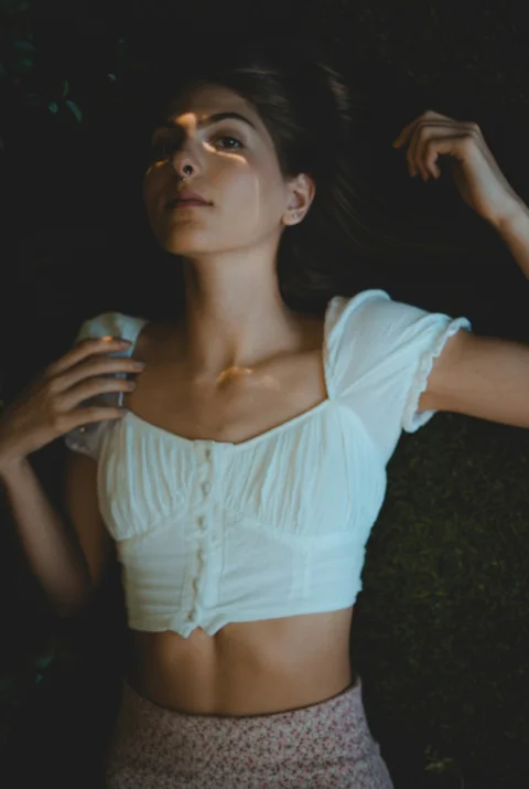 穿白色U領上衣和藍色牛仔熱褲的女子